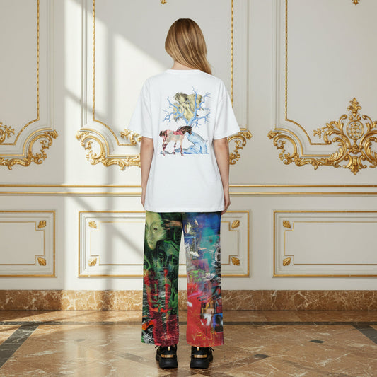 A model viewed from behind wearing a white t-shirt with a colorful graphic print on the back and matching multicolor patterned wide-leg pants, standing in a luxurious room with gold-trimmed cream walls and marble floors.
