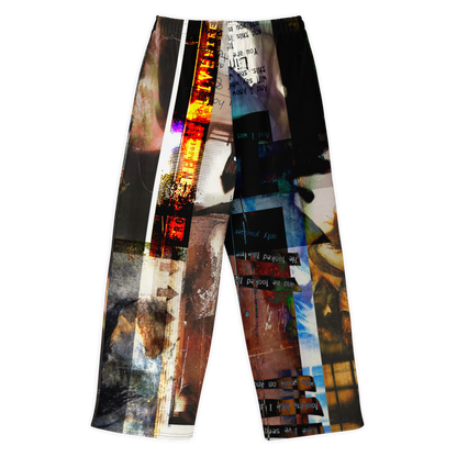 A pair of cropped athletic pants featuring a complex, multi-panel abstract collage print with vertical stripes of graffiti, textures, and graphic elements in black, white, blue, orange, and brown, shown against a plain white background.