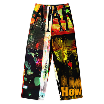 Wide-leg pants featuring a highly vibrant, multicolored abstract graffiti and paint-splatter print with bold text elements, shown against a plain white background.