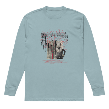 A light blue long-sleeve crewneck t-shirt with a central graphic print featuring a collage of a statue, a figure, and red scribbled lines, displayed on a clean white background.