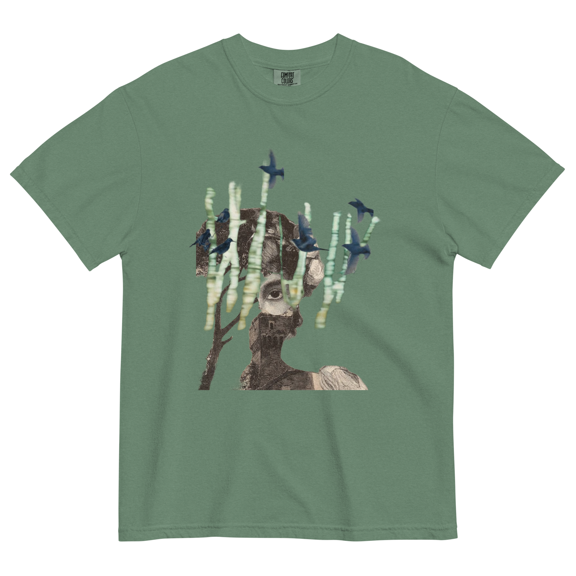 Green t-shirt with a graphic design of a person with trees and birds on a white background