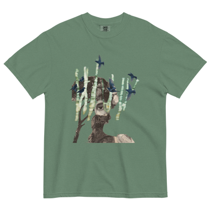 Green t-shirt with a graphic design of a person with trees and birds on a white background